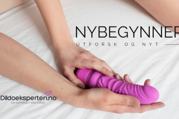 Dildo for nybegynnere – trygg, enkel og spennende start Dildo for nybegynner, kvinnehender holder en rosa dildo.